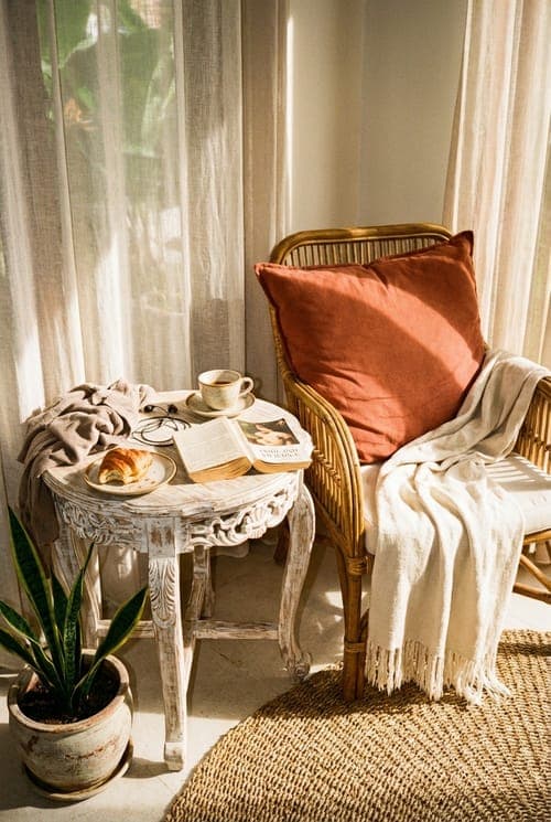Sunrise and the Weight of Pages - reading nook, rattan chair, terracotta