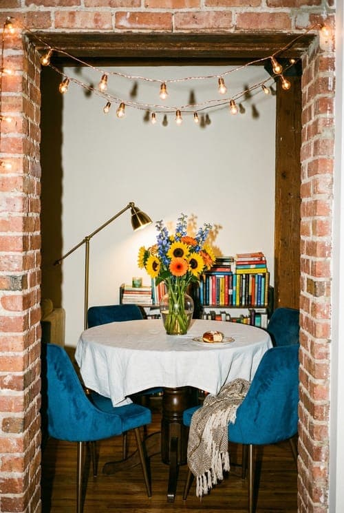Sunflowers Through a Brick Portal - dining room, sunflowers, blue chairs